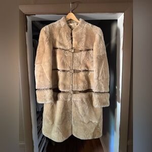 Vintage fur tan coat with belt featured. It’s close to a size medium